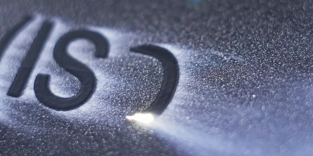 A metal piece being marked by a laser marking machine